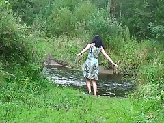 Young bitch shot pissing near the river